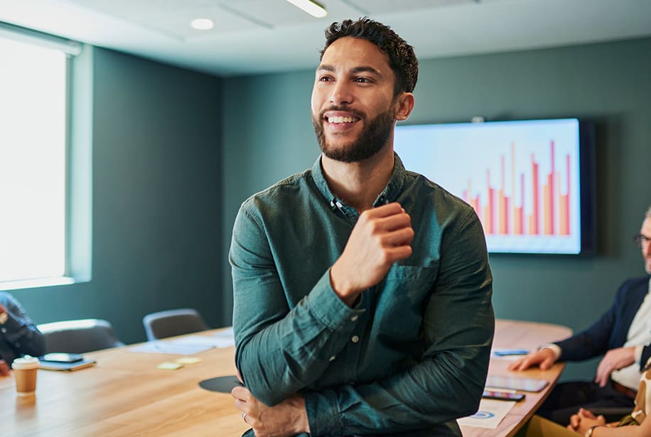 Smiling man in green shirt in office.