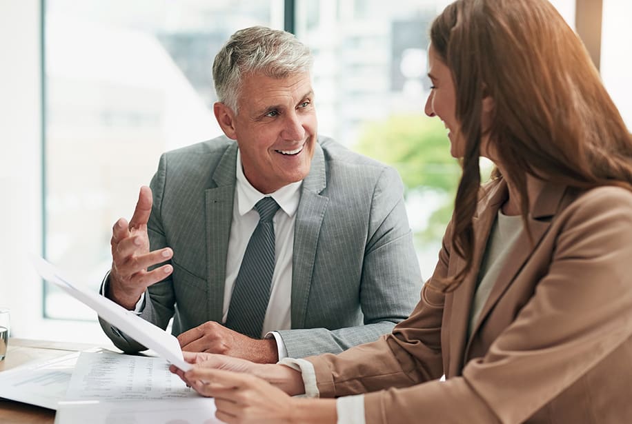 Businessman and woman reviewing documents.