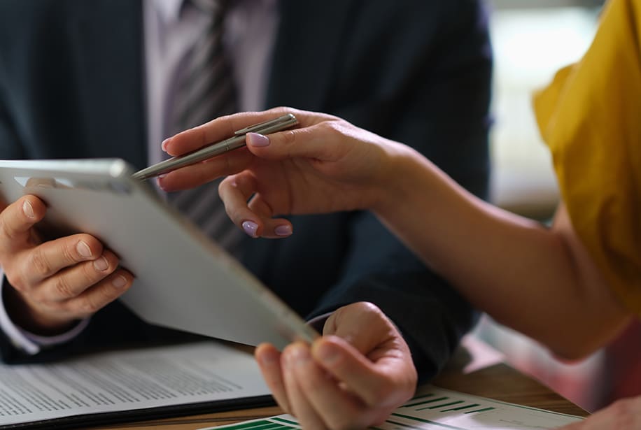 Business partners discussing a tablet.