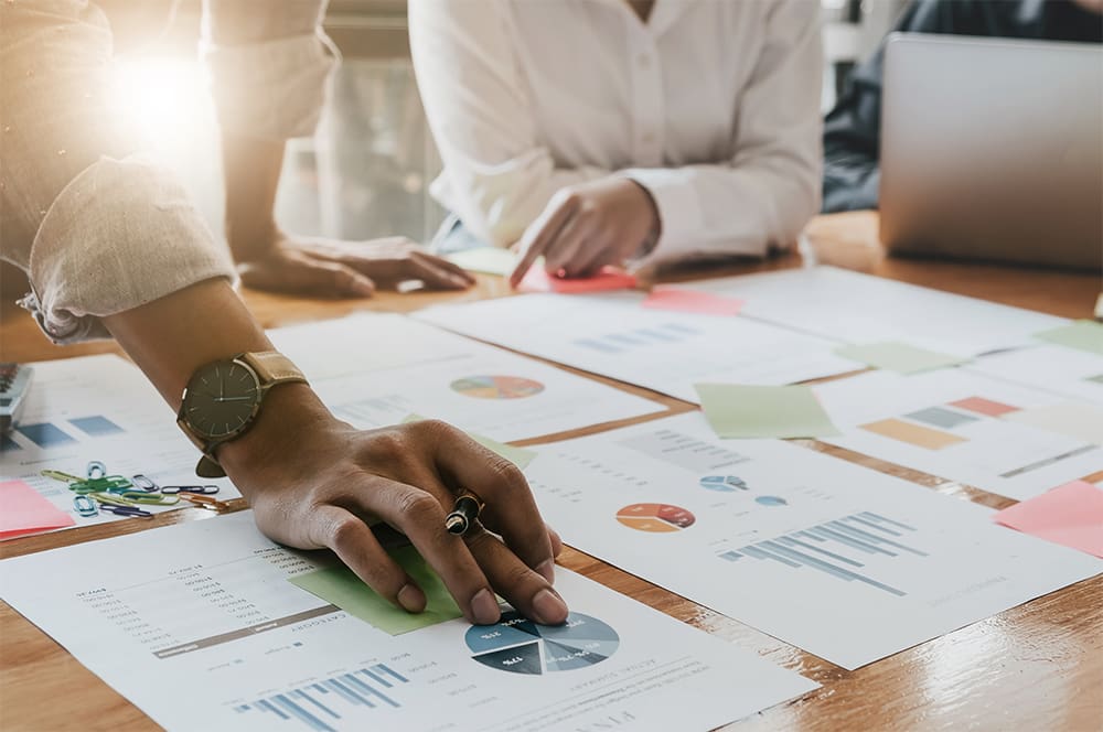 Person analyzing data on a table.