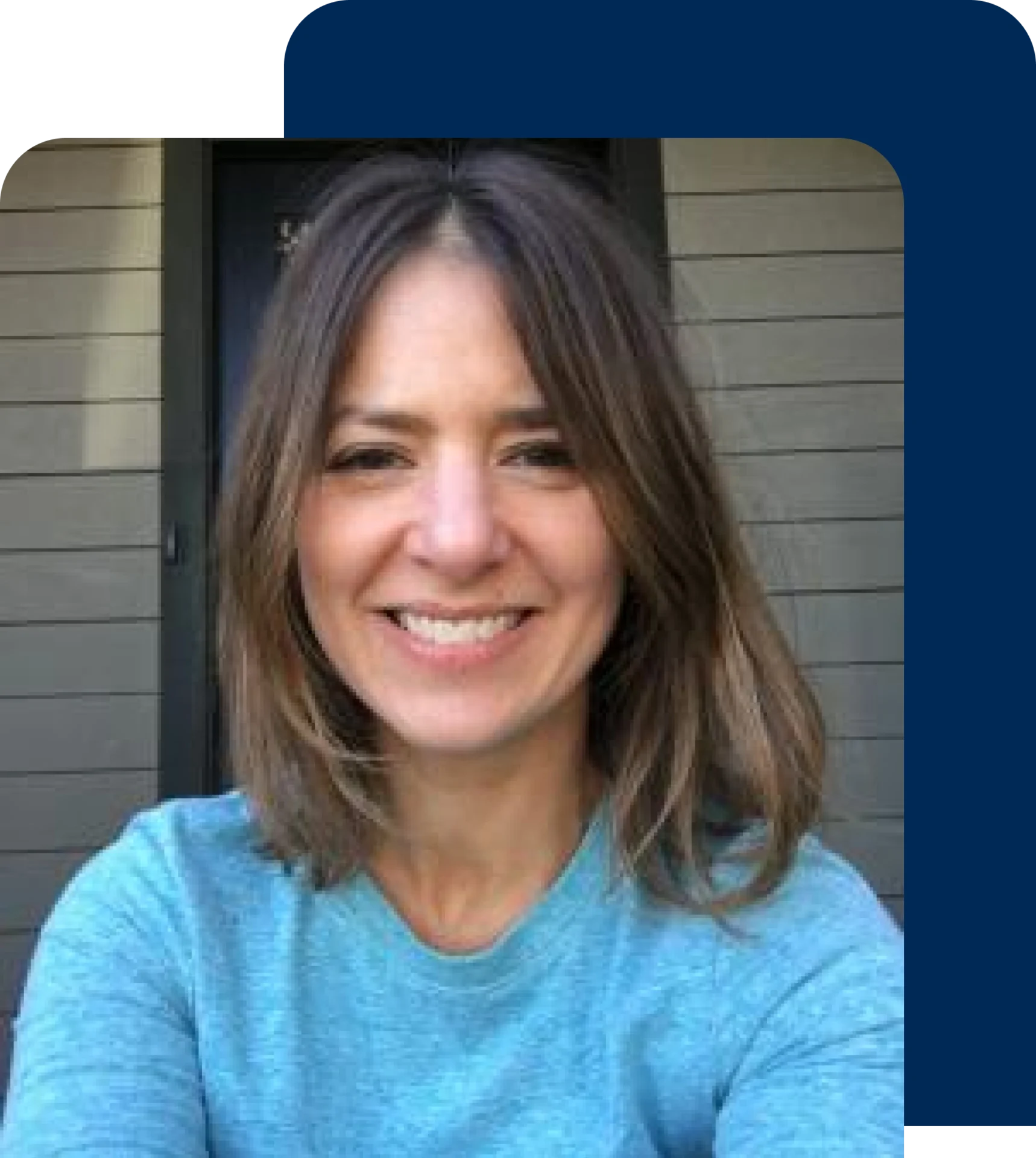 Woman smiling in a blue shirt.